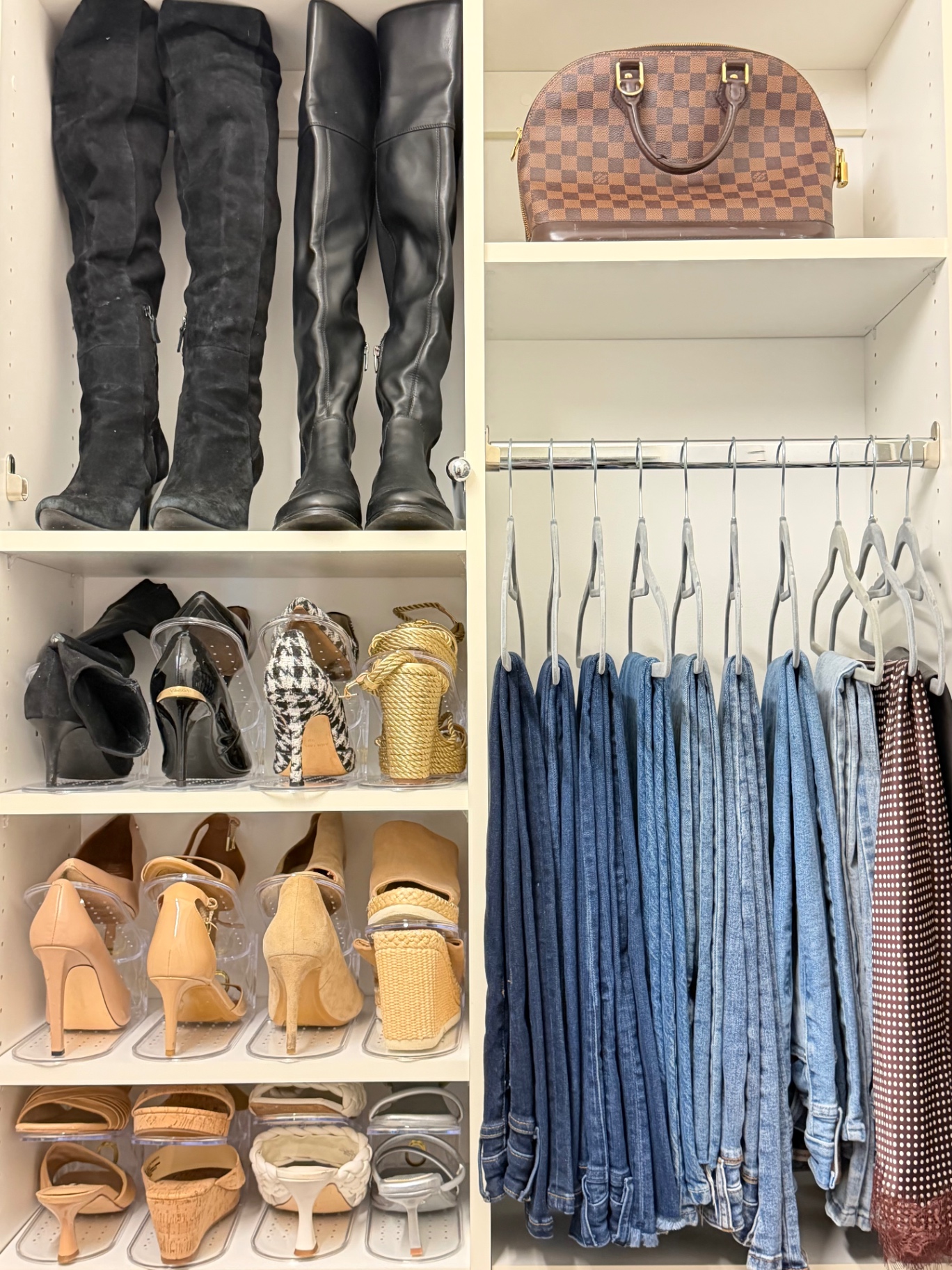 Organized luxury walk-in closet with matching hangers and warm wood shelving